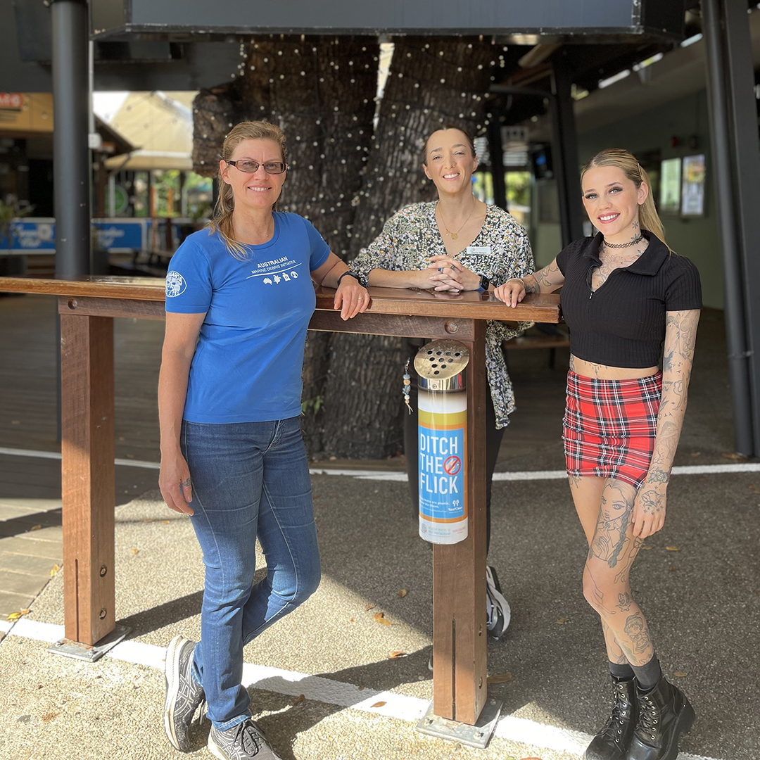 Tangaroa Blue Foundation CEO Heidi Tait, Healthy Rivers to Reef Chair Charlie Morgan, and Magnums Venue Manager Rebecca Cook stand around a cigarette butt bin.