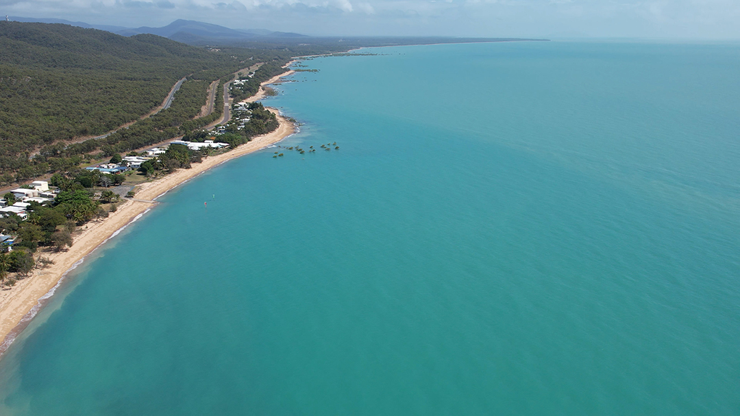 sip-overview-still-3 A drone image of a beach coastline at high-tide.