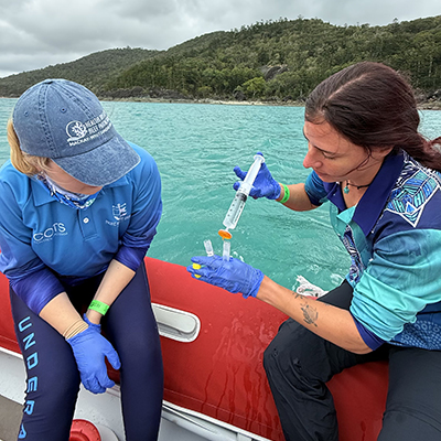 Project Officers Ashlee DeVore and Cinzia Cattaneo collect water samples as part of Project Blueprint.